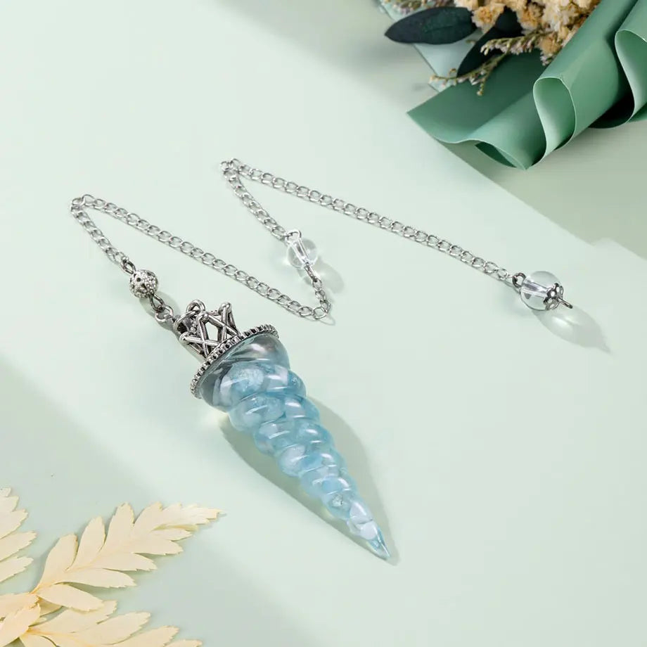 7-Chakra Aquamarine pendulum in resin form for reiki sessions, spiritual focus, and healing rituals.