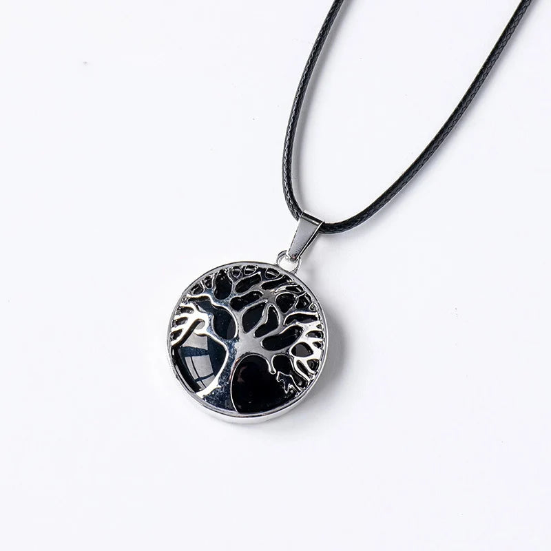 Silver necklace with a tree of life pendant on a white background