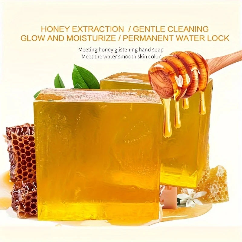 Bar of honey soap with honeycomb and honey drizzle, surrounded by honeycomb pieces and leaves on a white background.
