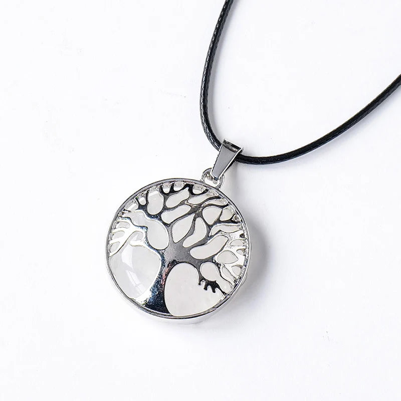 Silver tree of life pendant on a black cord against a white background