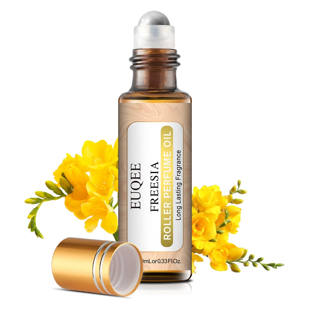 Roller bottle of Freesia perfume oil with yellow flowers on a white background
