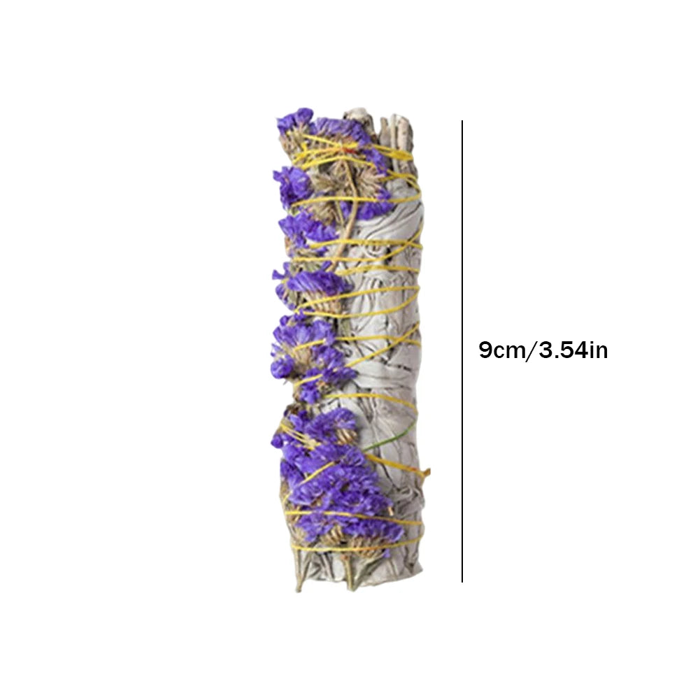 Bundled sage with purple flowers and yellow string on a white background