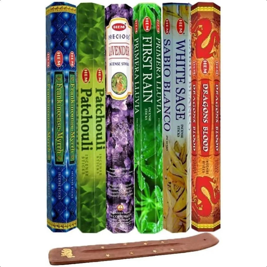 Collection of incense sticks with various scents and a wooden holder on a white background