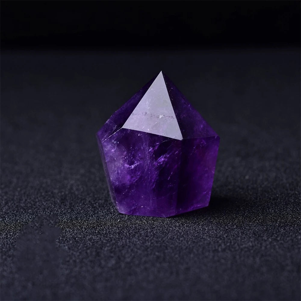 Purple crystal with a white triangular top on a black background
