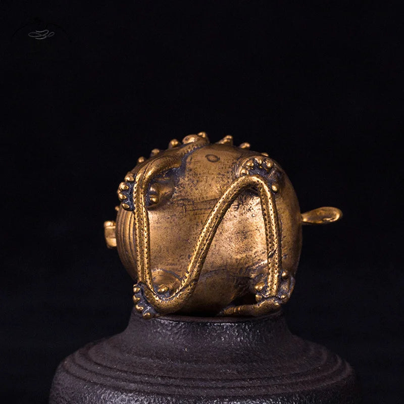 Gold-colored decorative object on a black background