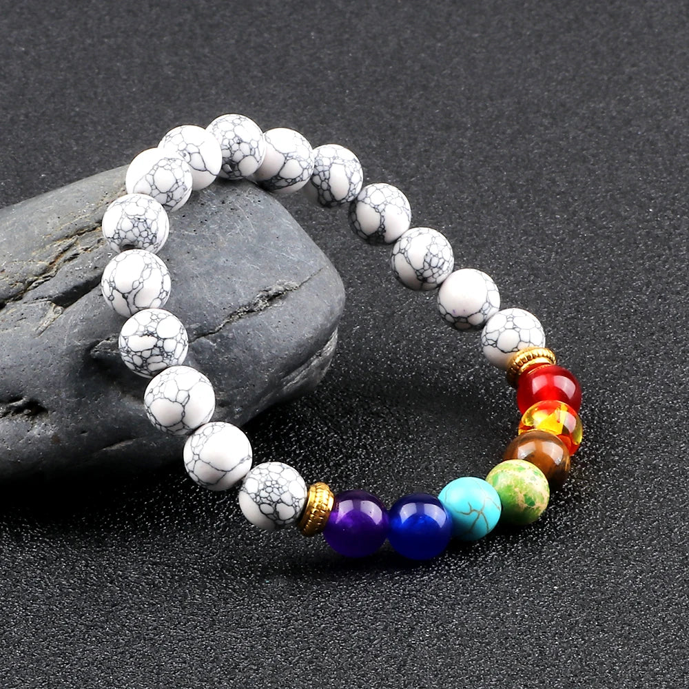 Bracelet with white beads and colorful beads on a dark surface