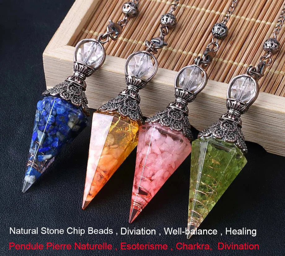 Four crystal pendulums with colored stones on a wooden surface, branded 'Cristal Jewelry'.