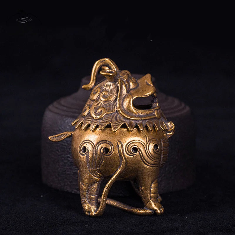 Bronze lion incense burner on a black background