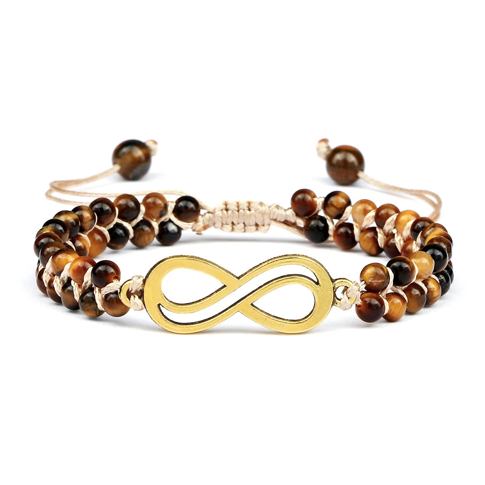 Beaded bracelet with gold infinity symbol on a white background