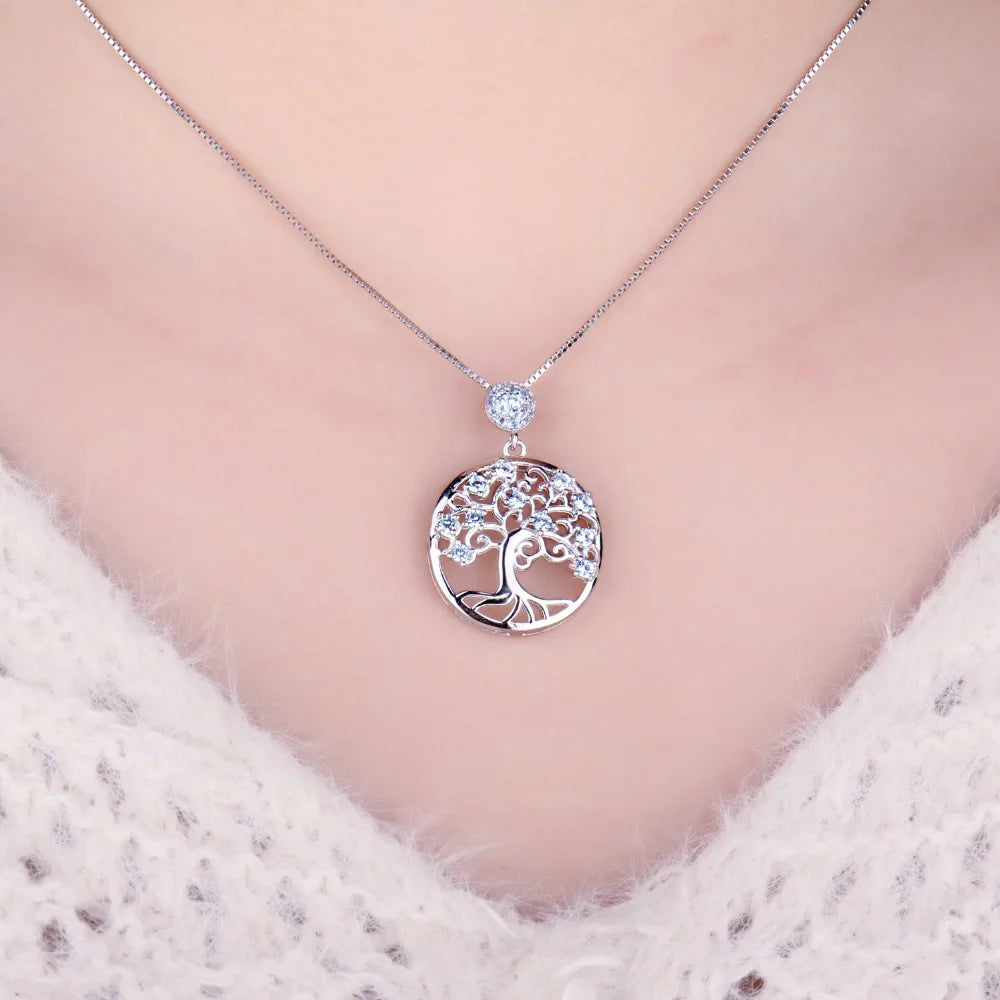 Necklace with a tree of life pendant on a soft pink background