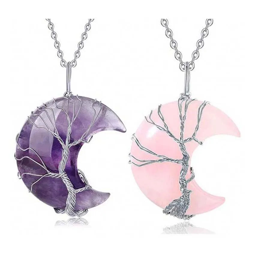 Two crescent moon-shaped pendants, one purple and one pink, on silver chains against a white background.