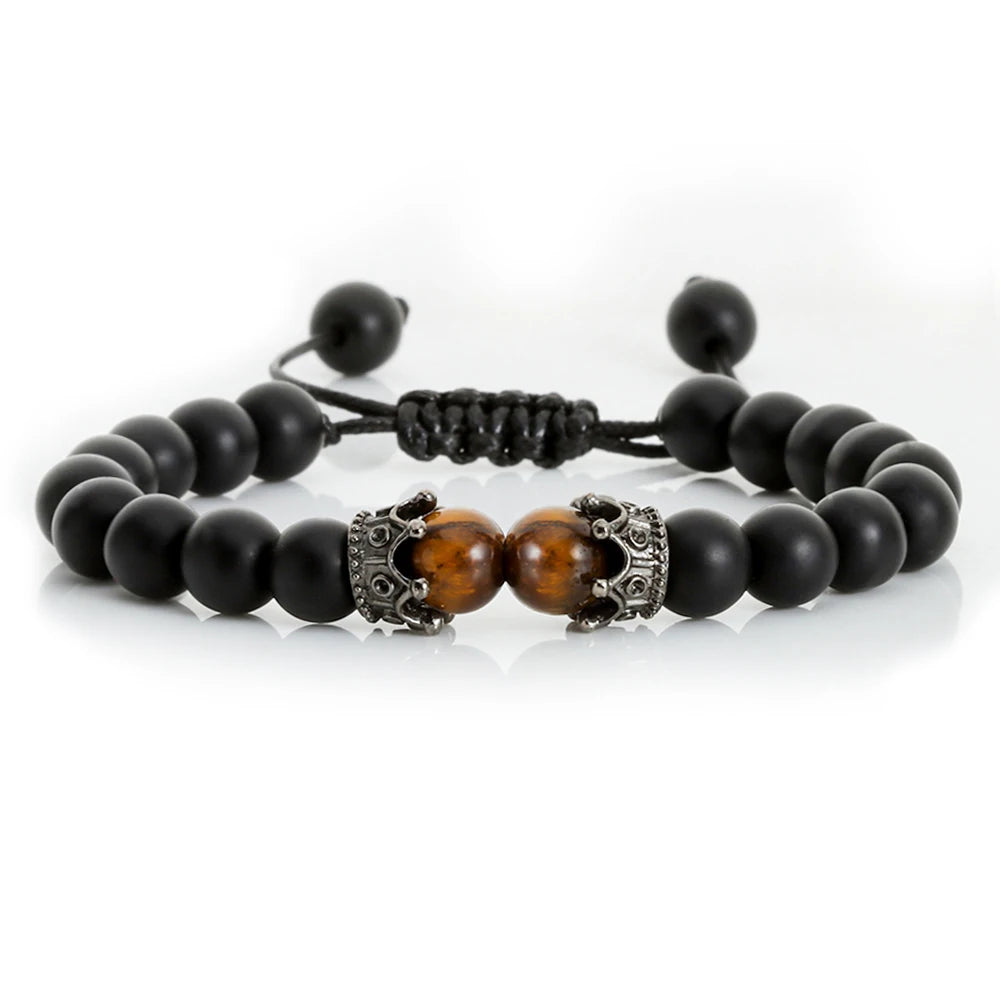 Black beaded bracelet with a brown tiger eye stone and silver clasp on a white background
