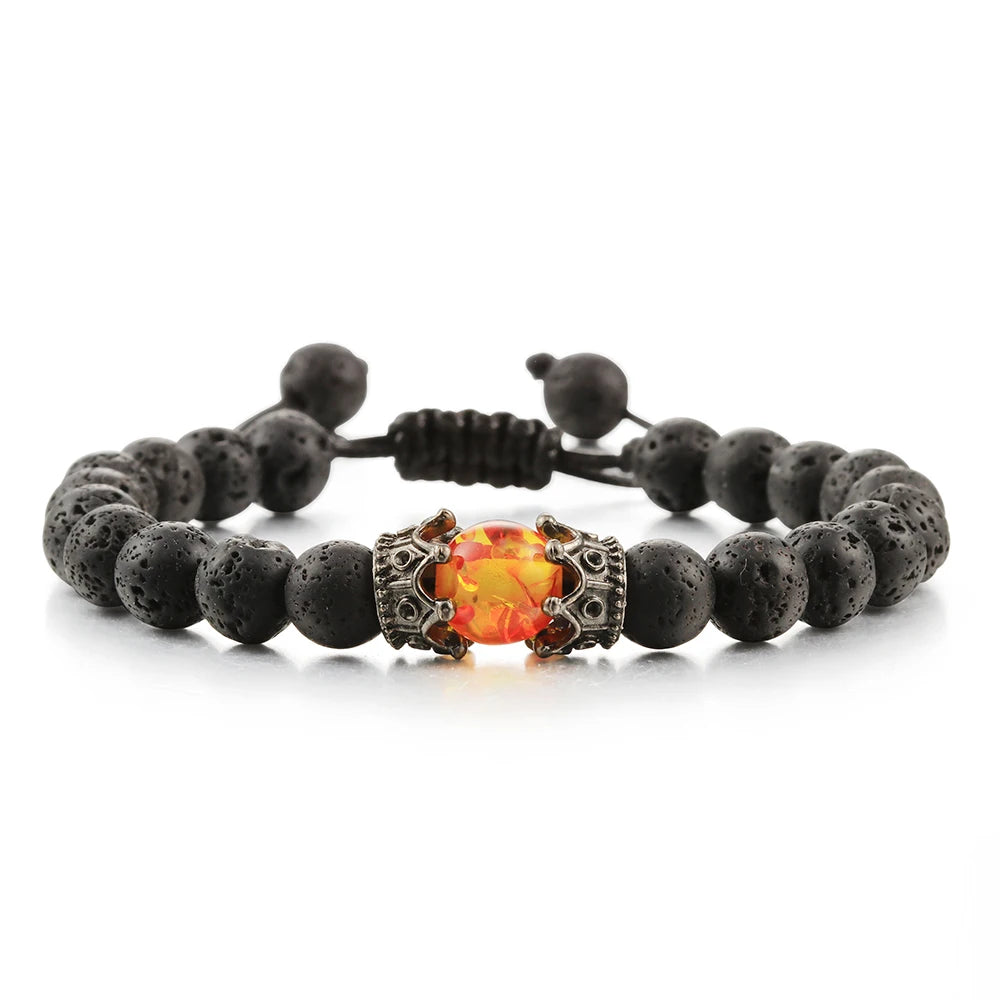 Bracelet with black beads and a central orange gemstone on a white background