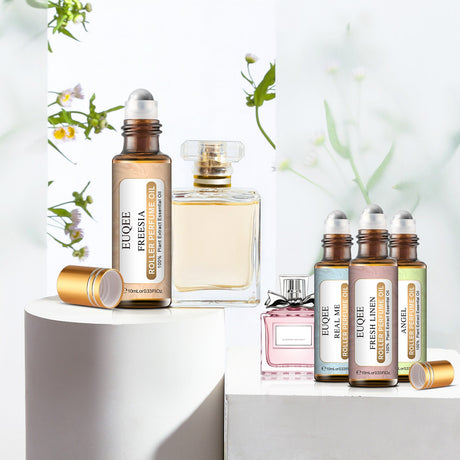 Collection of Eloee perfume bottles on a white surface with a light background