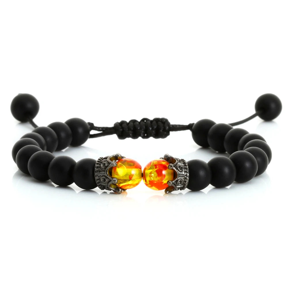 Black beaded bracelet with fiery red and yellow beads on a white background