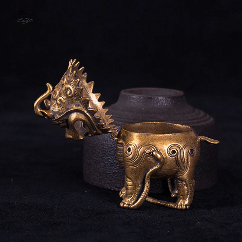 Bronze elephant-shaped container with dragon head on a black background