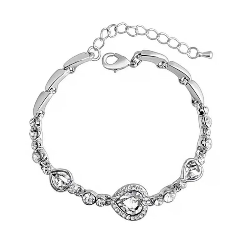 Silver bracelet with heart-shaped crystals on a white background