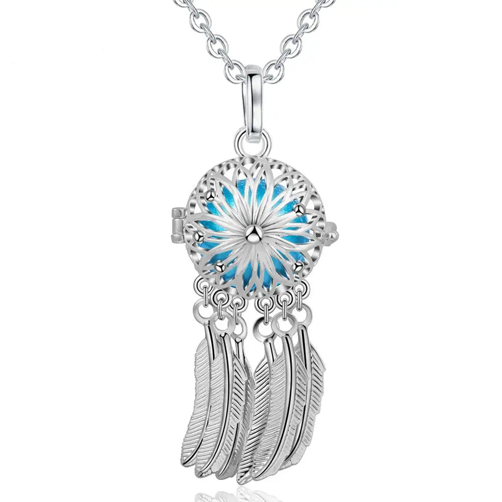 Silver dreamcatcher necklace with blue center and feathers, brand 'Eudora' visible.