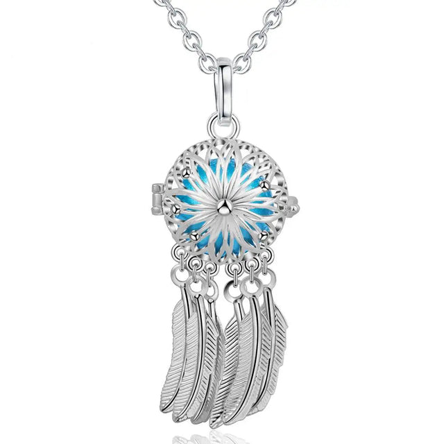 Silver dreamcatcher necklace with blue center and feathers, brand 'Eudora' visible.