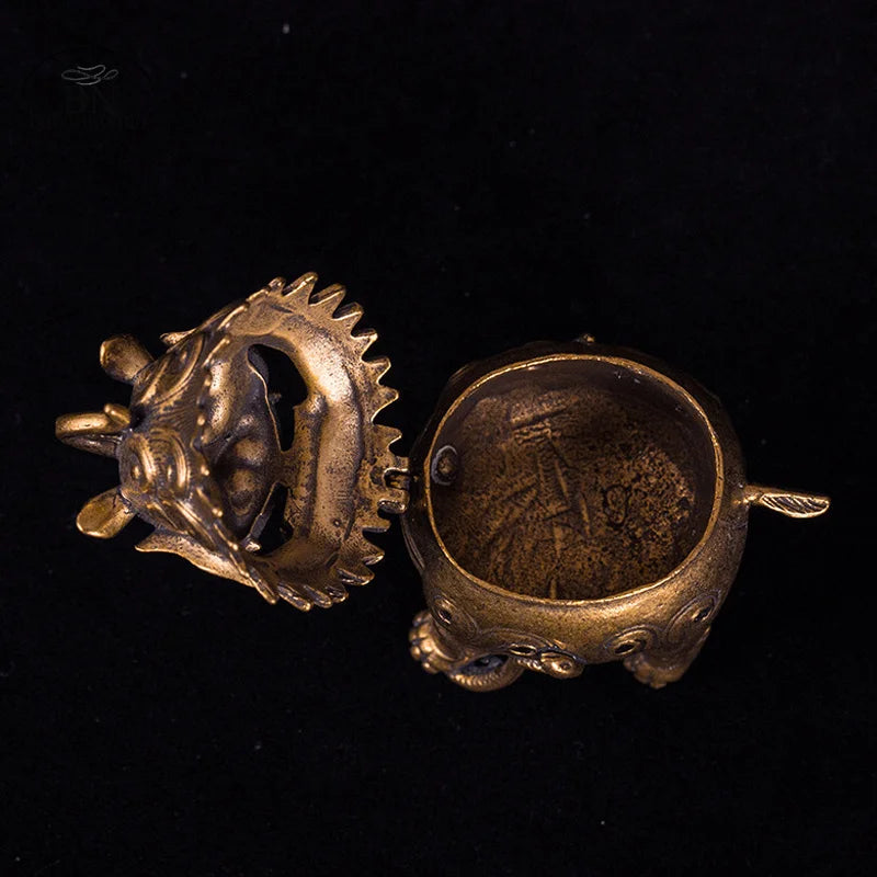 Bronze dragon-shaped object on a black background