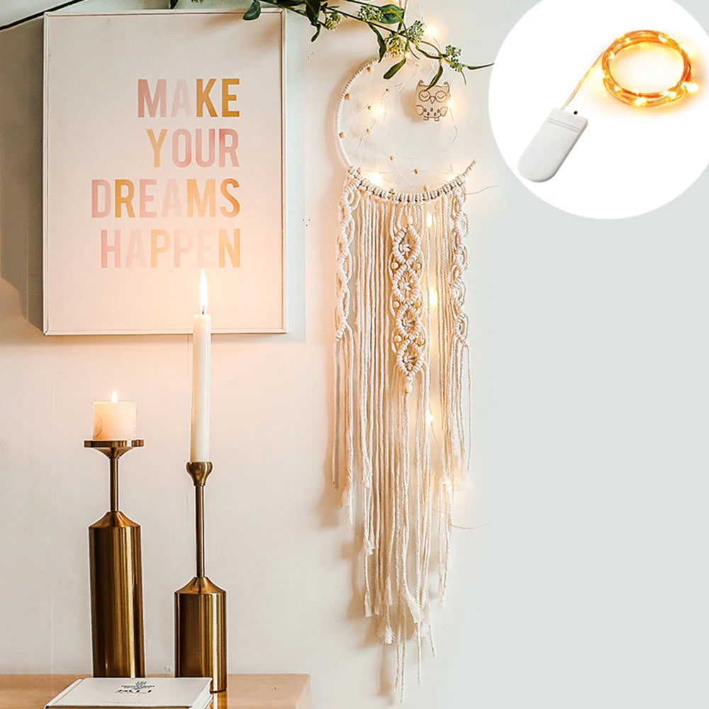Decorative wall art with 'Make Your Dreams Happen' poster, dreamcatcher, and string lights.