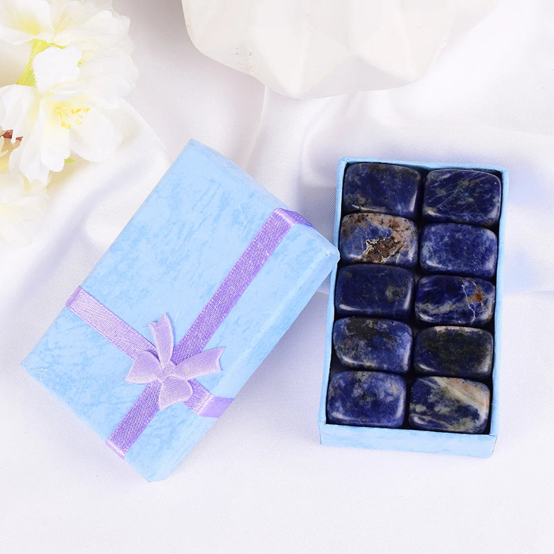 Box of stones with a decorative ribbon on a white background