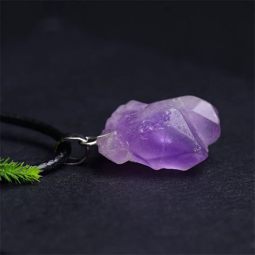 Purple crystal pendant on a dark background