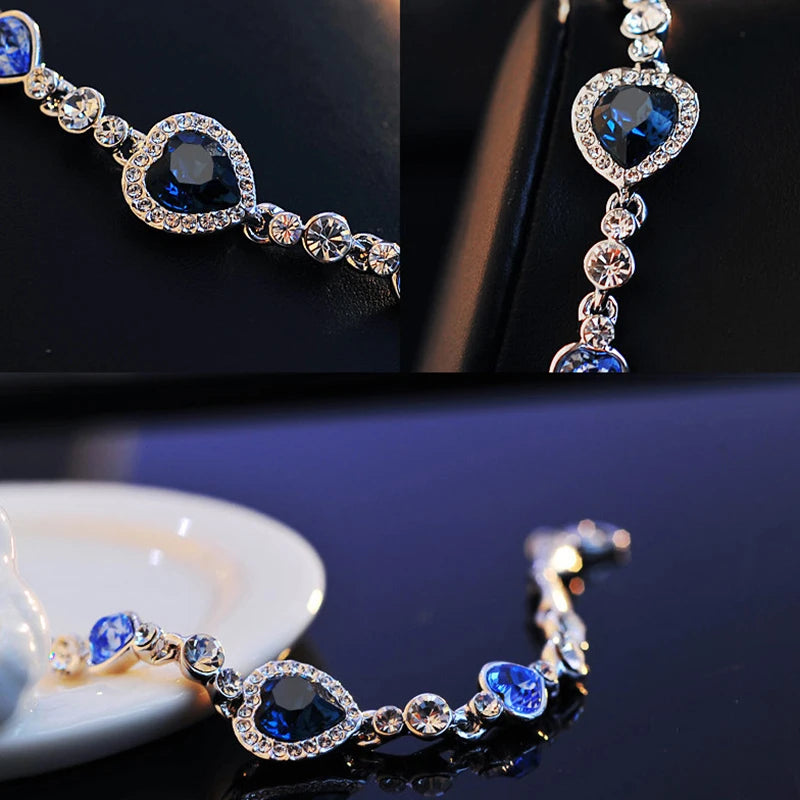 Silver bracelet with blue gemstones on a dark surface