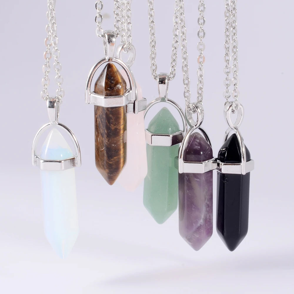 Five crystal pendant necklaces on a white background