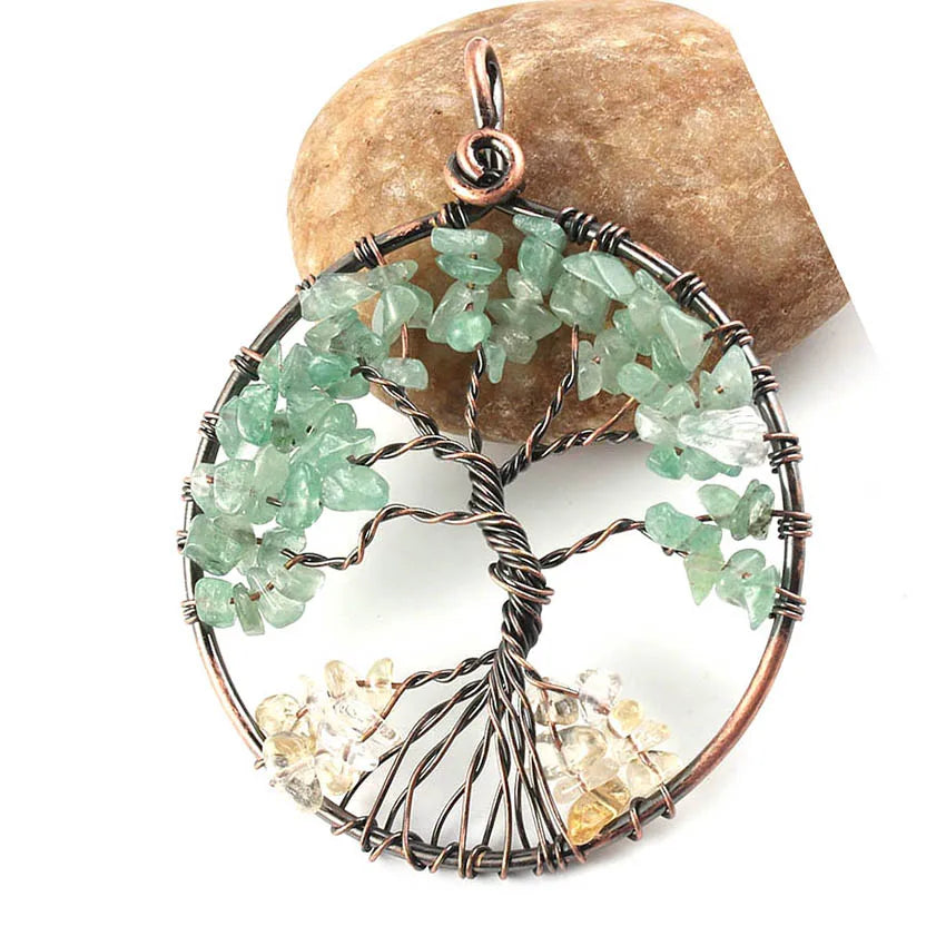 Tree-shaped pendant with green and yellow stones on a rock