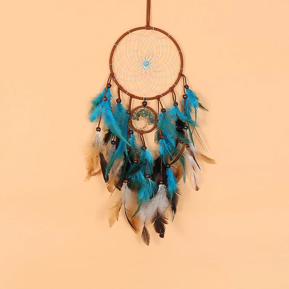 Dreamcatcher with blue feathers on a beige background