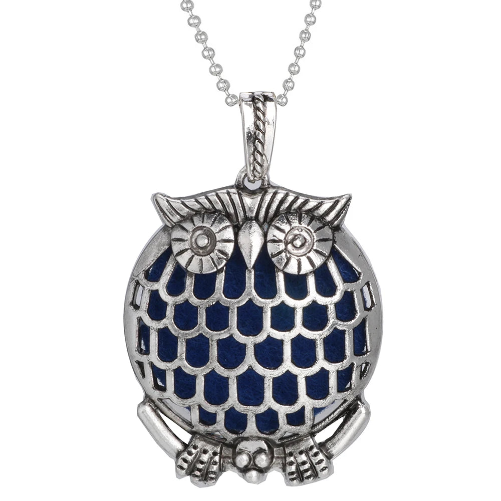 Silver owl pendant with blue accents on a white background