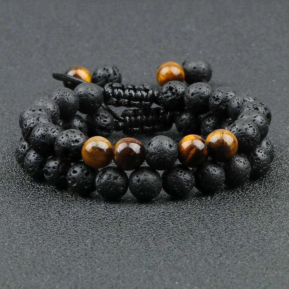 Black and brown beaded bracelets on a dark surface