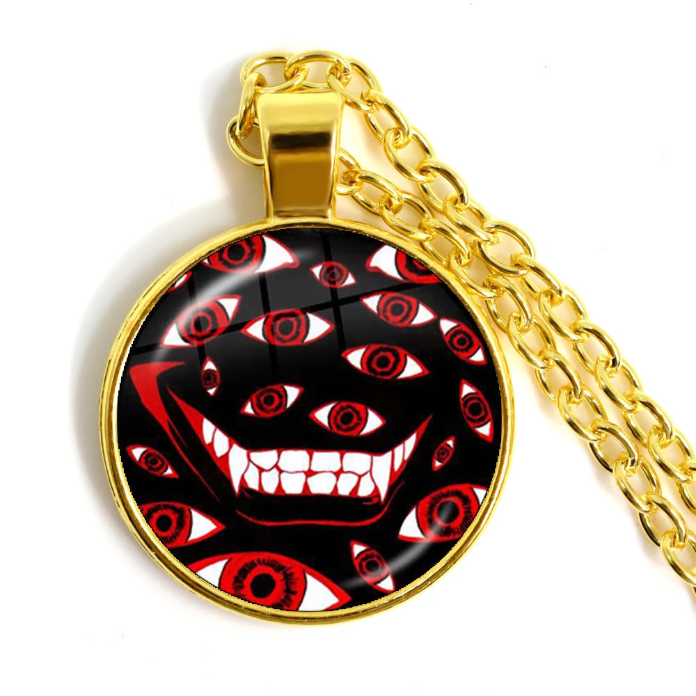 Gold chain necklace with a pendant featuring a red and white design on a black background