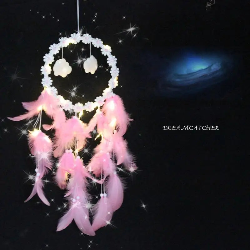 Pink dreamcatcher with lights against a dark background