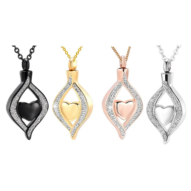 Four heart-shaped pendant necklaces in black, gold, rose gold, and silver on a white background.