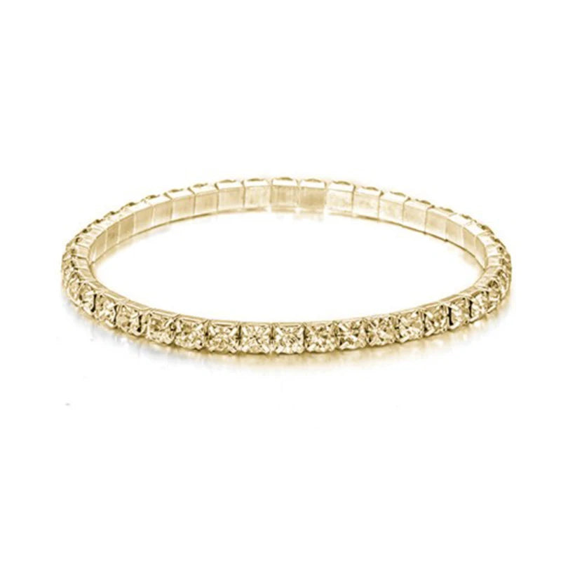 Gold bracelet with small diamonds on a white background