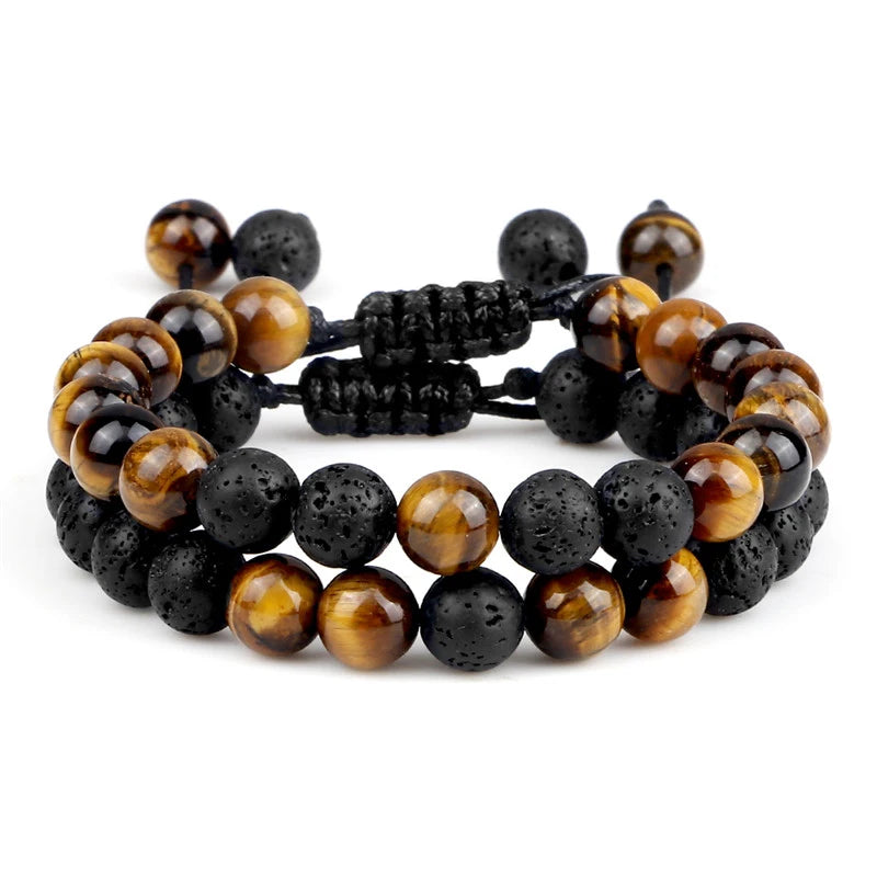Set of three beaded bracelets with tiger eye and black stones on a white background