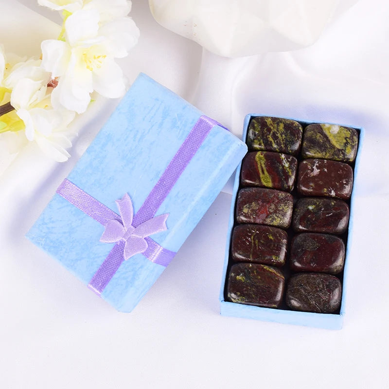 Box of chocolates with a decorative ribbon on a white background