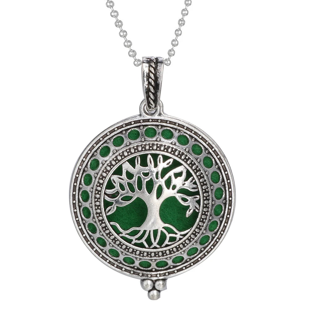 Silver pendant with green tree design on a white background