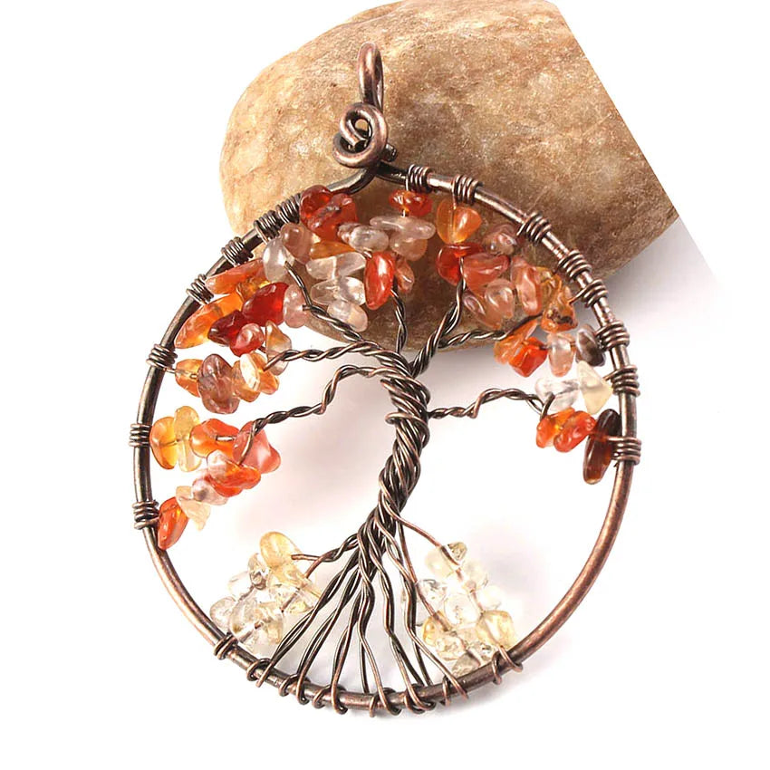 Tree-shaped jewelry pendant with multicolored stones on a white background