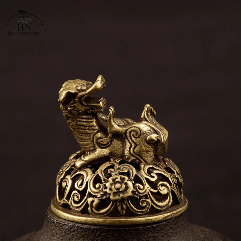 Bronze dragon sculpture on a dark background
