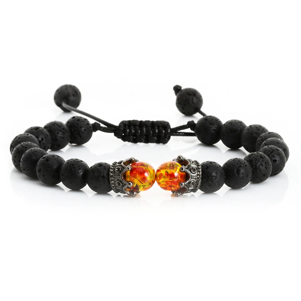 Black beaded bracelet with orange and silver beads on a white background
