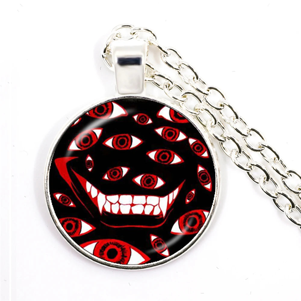 Pendant with a design of a face with red eyes and a black background on a white background