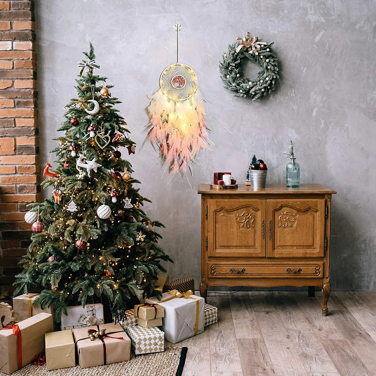 Decorated Christmas tree with presents, wooden cabinet, and wall decorations in a room.