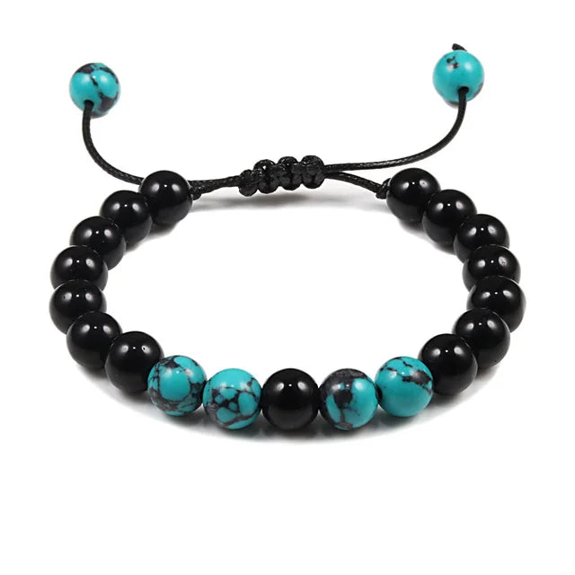 Black and turquoise beaded bracelet on a white background