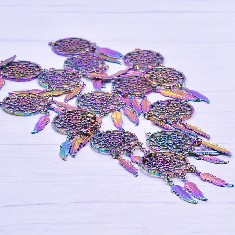 Iridescent dreamcatcher-shaped charms on a white background