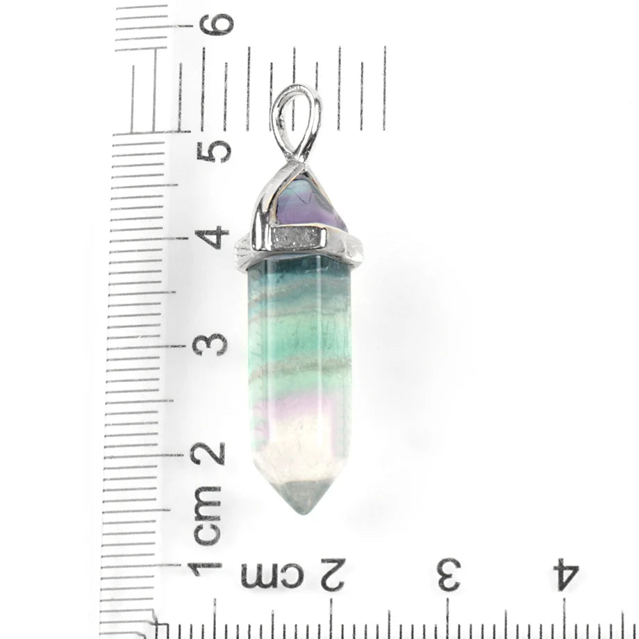 Crystal pendant with silver top on a ruler for scale