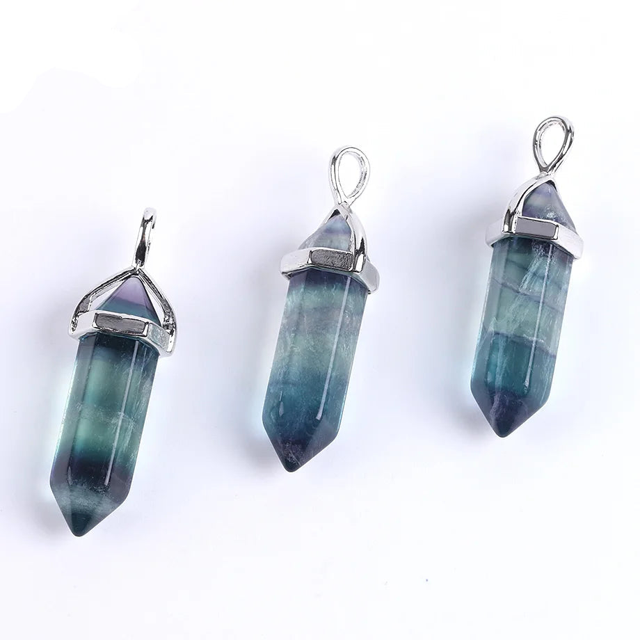 Three crystal pendants with silver settings on a white background, branded 'Crista'.