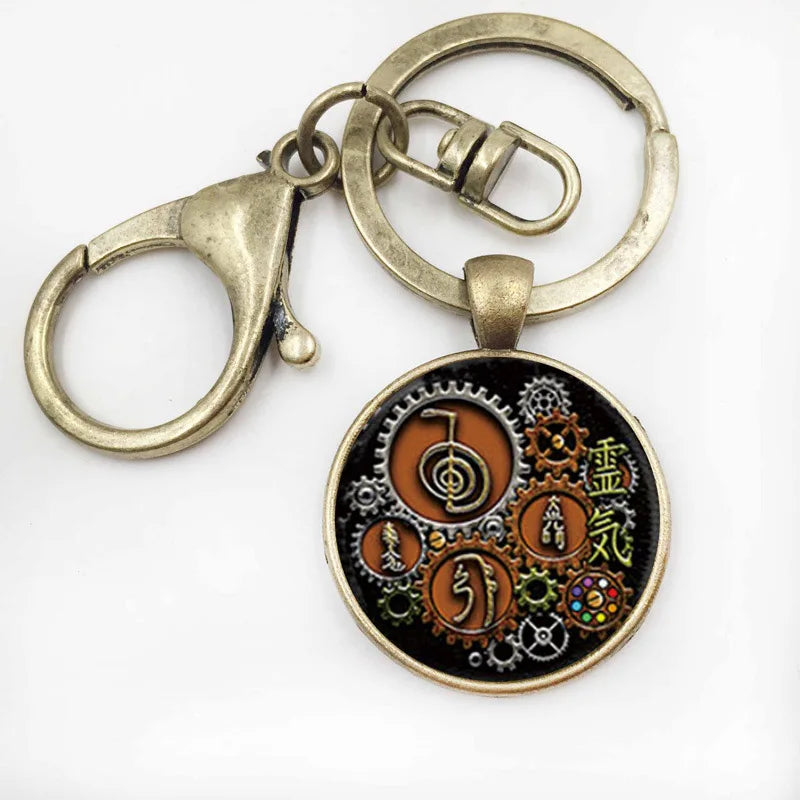 Keychain with circular pendant featuring intricate designs on a white background